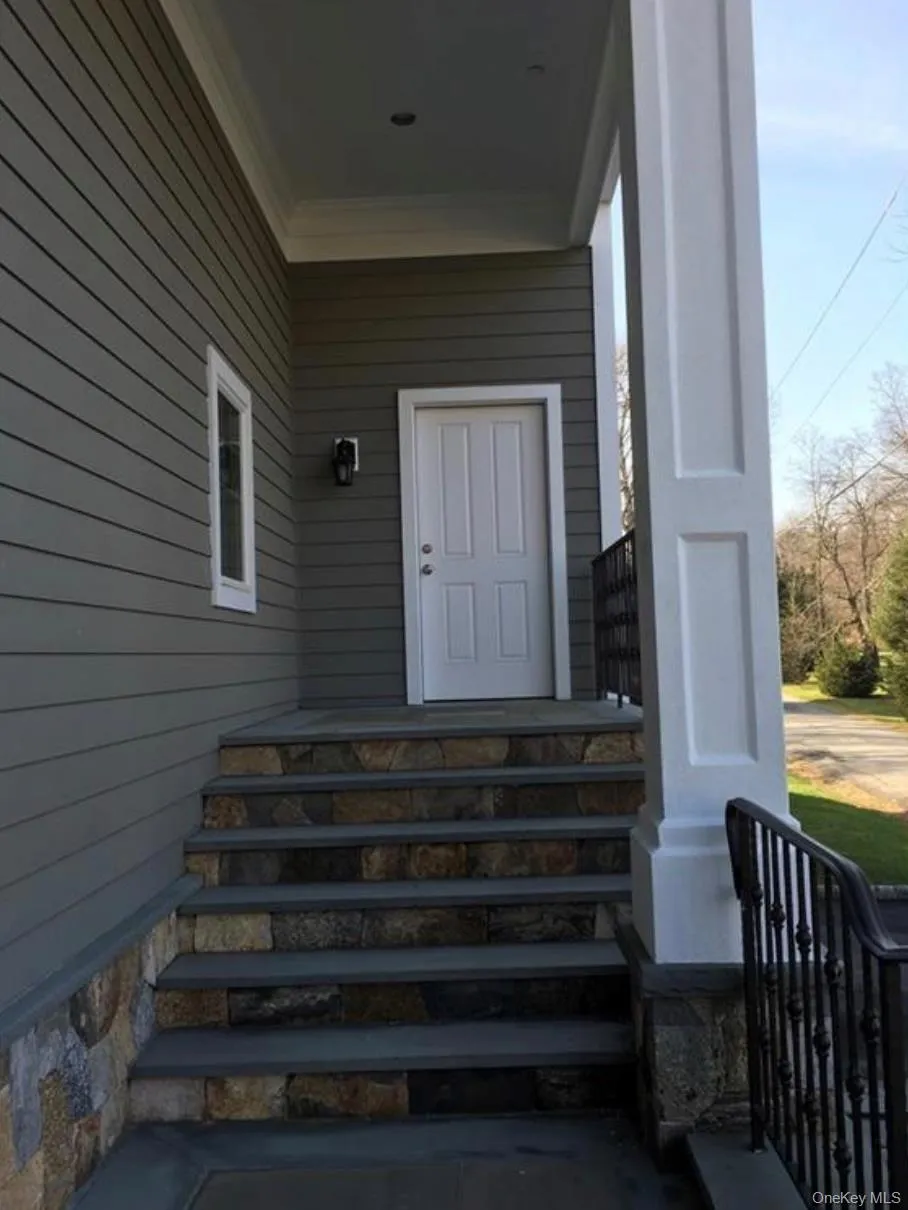 Property entrance featuring covered porch, stairs to unit on second floor. Property entrance featuring covered porch, stairs to unit on second floor.