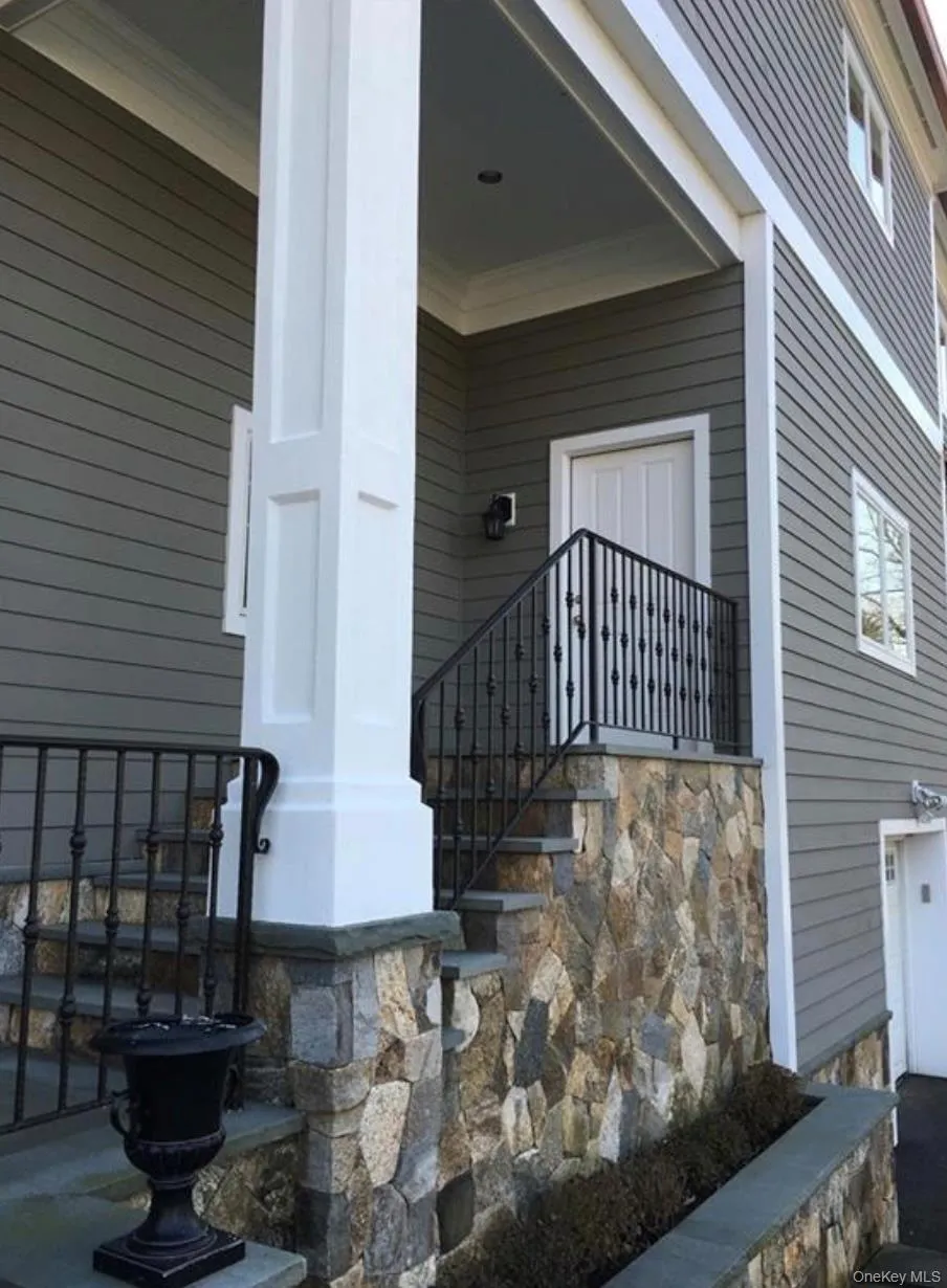 Property entrance featuring covered porch, stairs to unit on second floor. Property entrance featuring covered porch, stairs to unit on second floor.