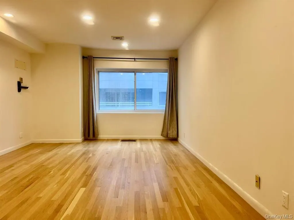 Spare room with light wood-type flooring and recessed lighting Spare room with light wood-type flooring and recessed lighting