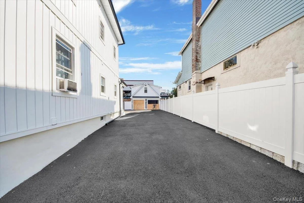 View of side of property featuring board and batten siding and a detached garage View of side of property featuring board and batten siding and a detached garage