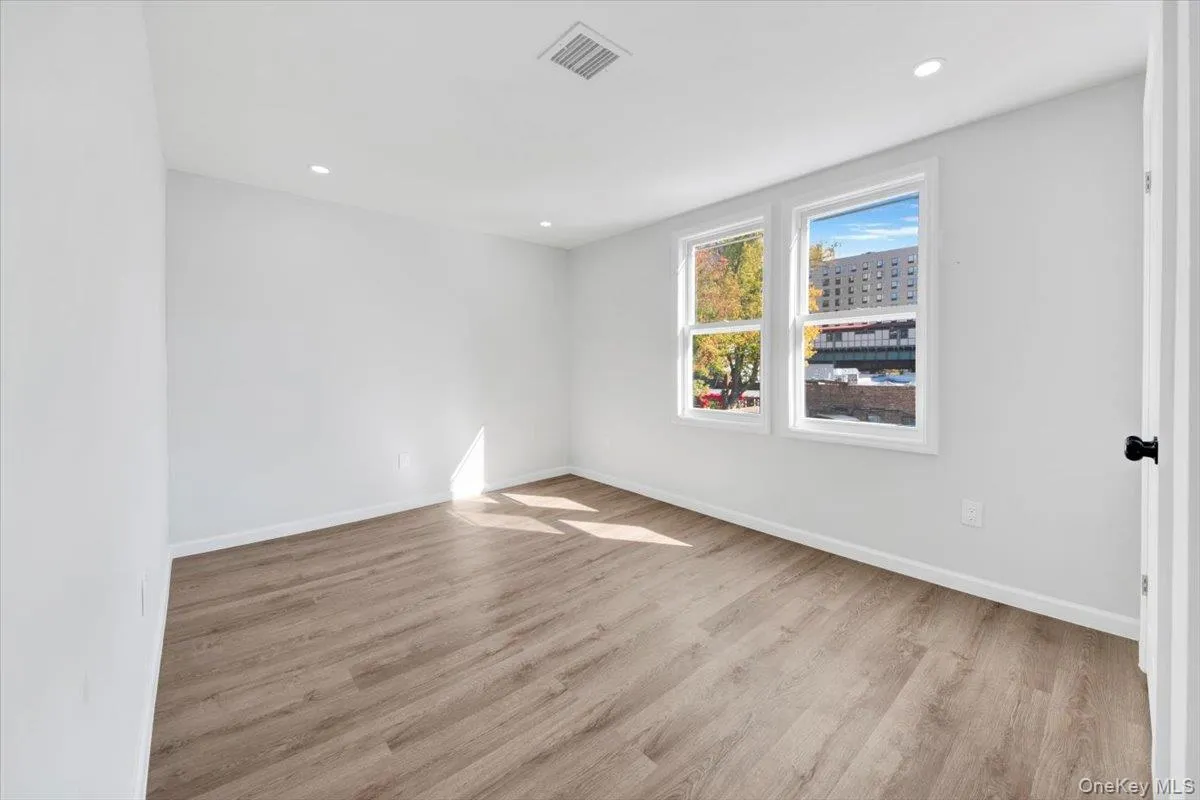 Empty room with light wood-style floors and recessed lighting Empty room with light wood-style floors and recessed lighting