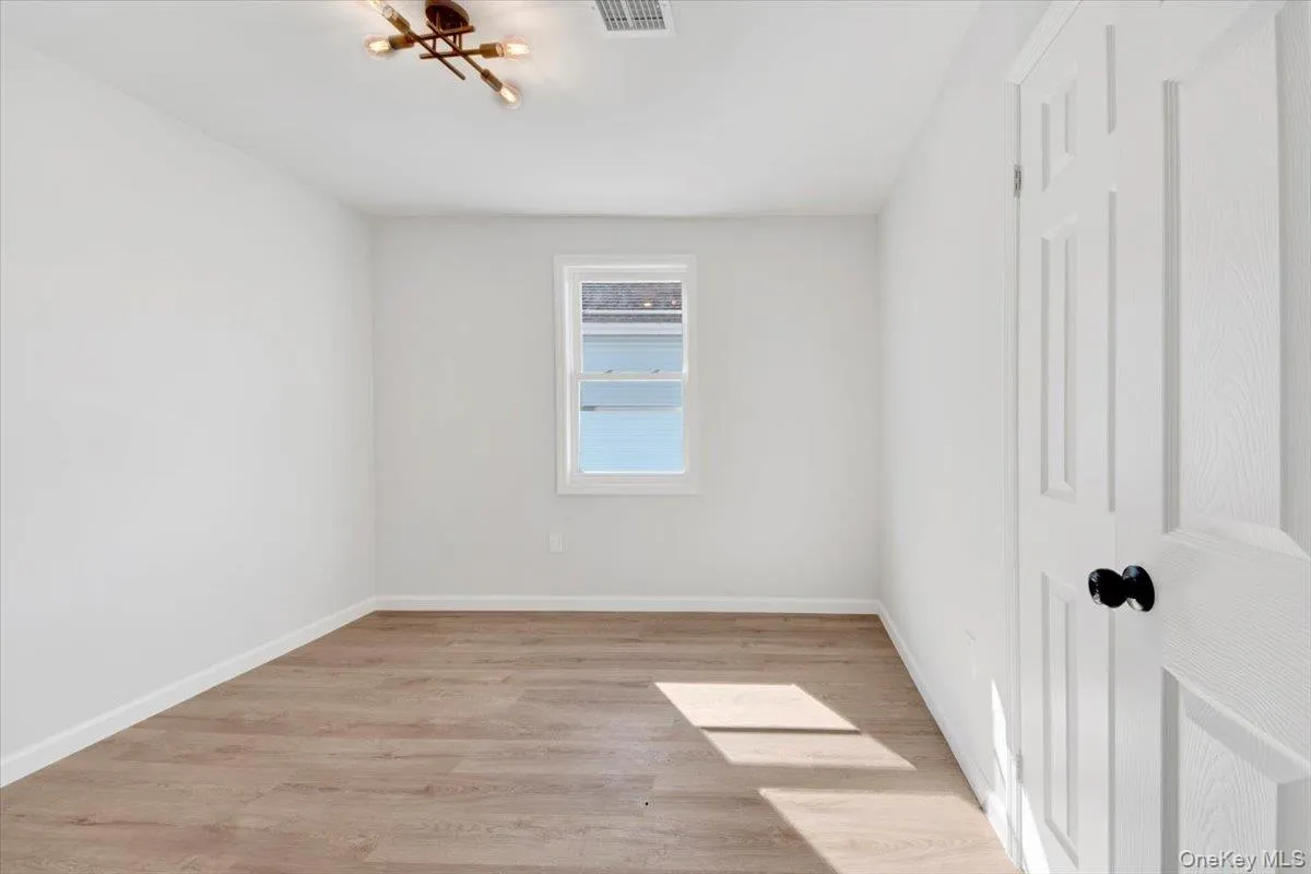 Unfurnished room featuring light wood-type flooring and baseboards Unfurnished room featuring light wood-type flooring and baseboards