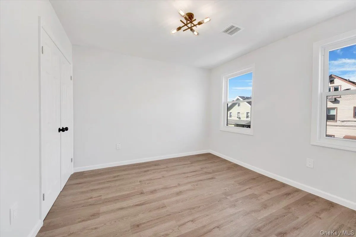 Empty room featuring light wood-style floors and baseboards Empty room featuring light wood-style floors and baseboards