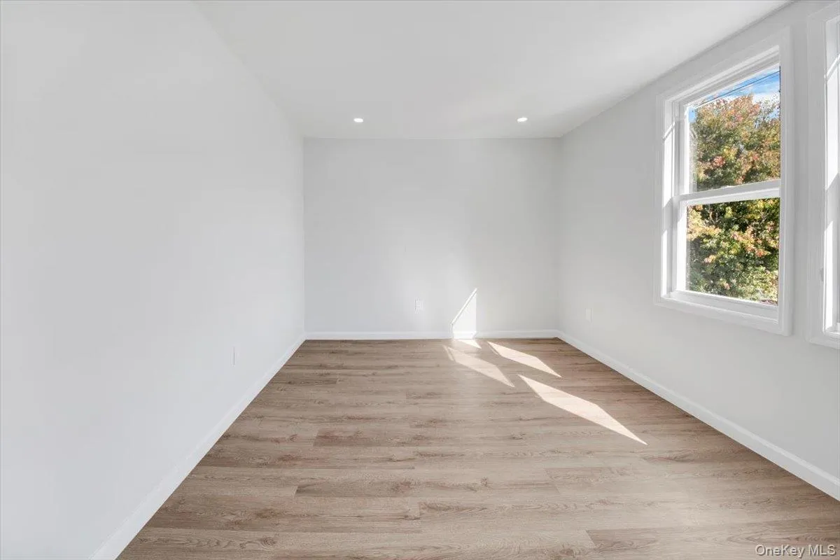 Unfurnished room with light wood-style flooring and recessed lighting Unfurnished room with light wood-style flooring and recessed lighting