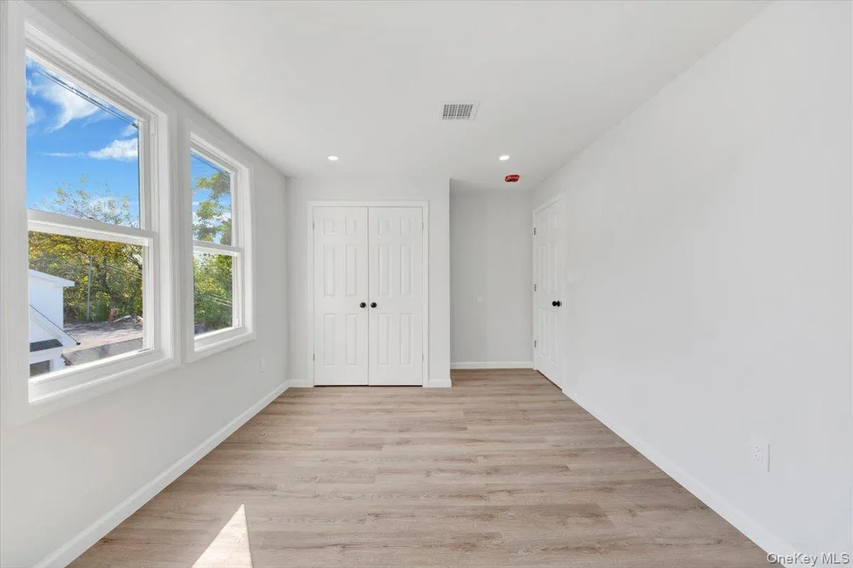 Unfurnished bedroom featuring light wood-style floors, recessed lighting, and a closet Unfurnished bedroom featuring light wood-style floors, recessed lighting, and a closet