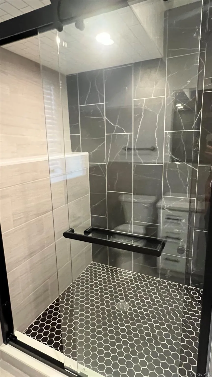 Full bathroom featuring a stall shower Full bathroom featuring a stall shower