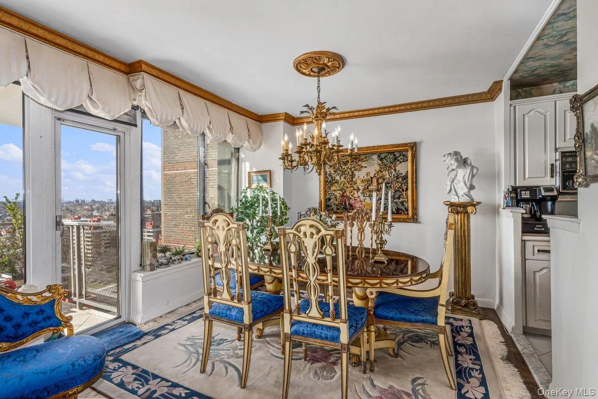 Dining space with ornamental molding and a chandelier Dining space with ornamental molding and a chandelier