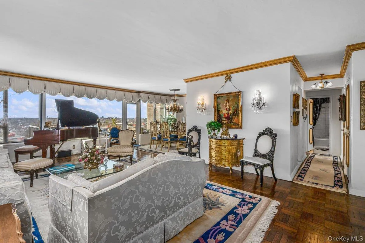 Living area with a chandelier and ornamental molding Living area with a chandelier and ornamental molding