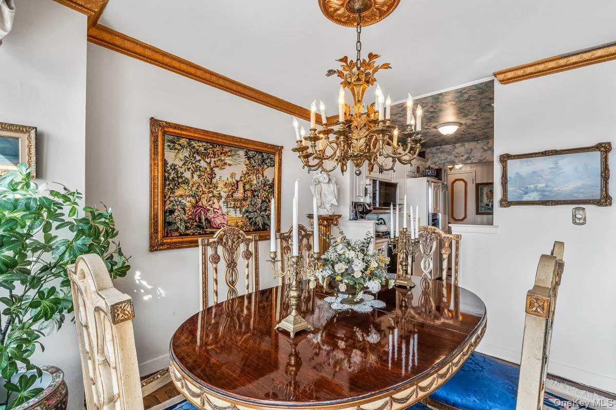 Dining space featuring ornamental molding and a chandelier Dining space featuring ornamental molding and a chandelier