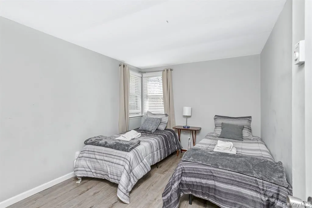 Bedroom with wood finished floors and baseboards Bedroom with wood finished floors and baseboards