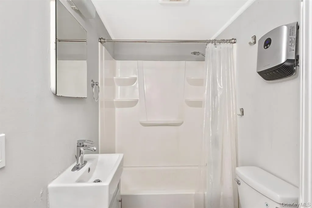 Bathroom featuring vanity and shower / tub combo with curtain Bathroom featuring vanity and shower / tub combo with curtain