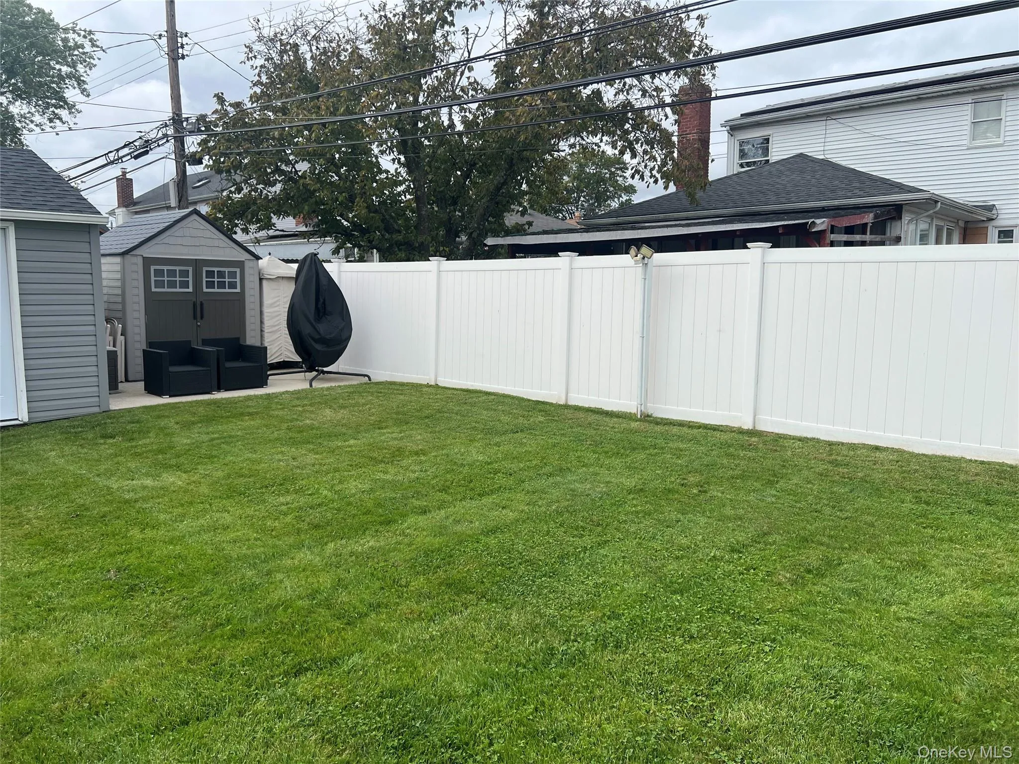 Fenced backyard featuring a patio and a storage shed Fenced backyard featuring a patio and a storage shed