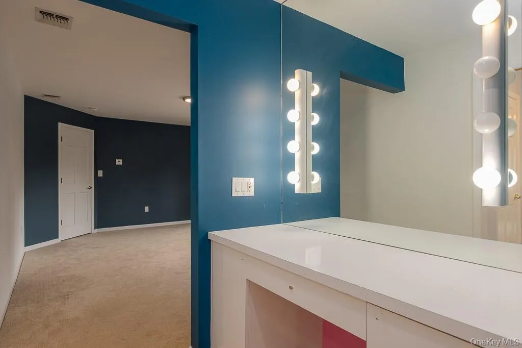 Bathroom with light carpet and baseboards Bathroom with light carpet and baseboards