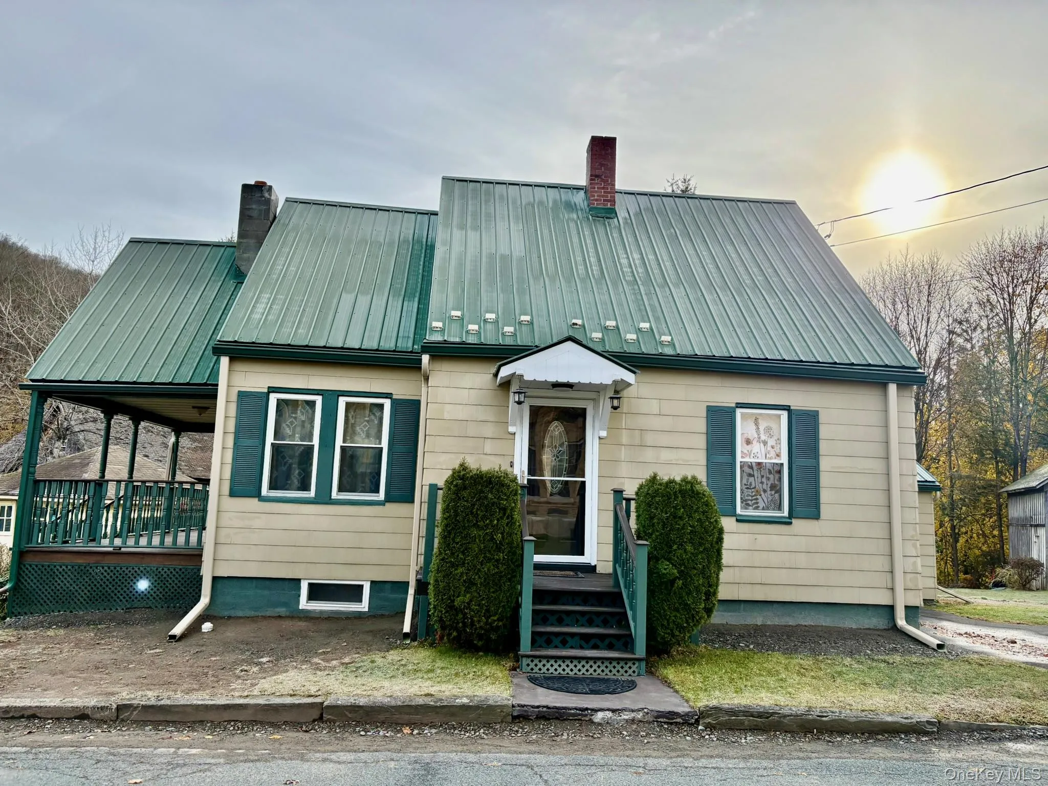 View of front of home featuring a chimney and a metal roof View of front of home featuring a chimney and a metal roof