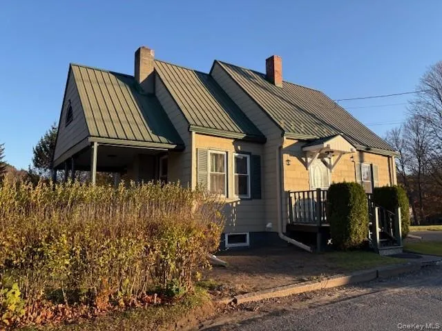 View of side of property with a chimney, a metal roof, and a standing seam roof View of side of property with a chimney, a metal roof, and a standing seam roof