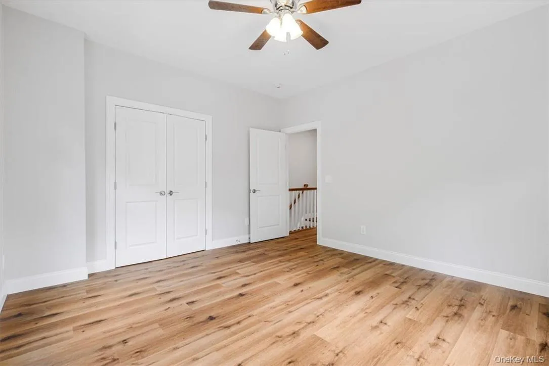 Unfurnished bedroom featuring light hardwood / wood-style floors, ceiling fan, and a closet Unfurnished bedroom featuring light hardwood / wood-style floors, ceiling fan, and a closet