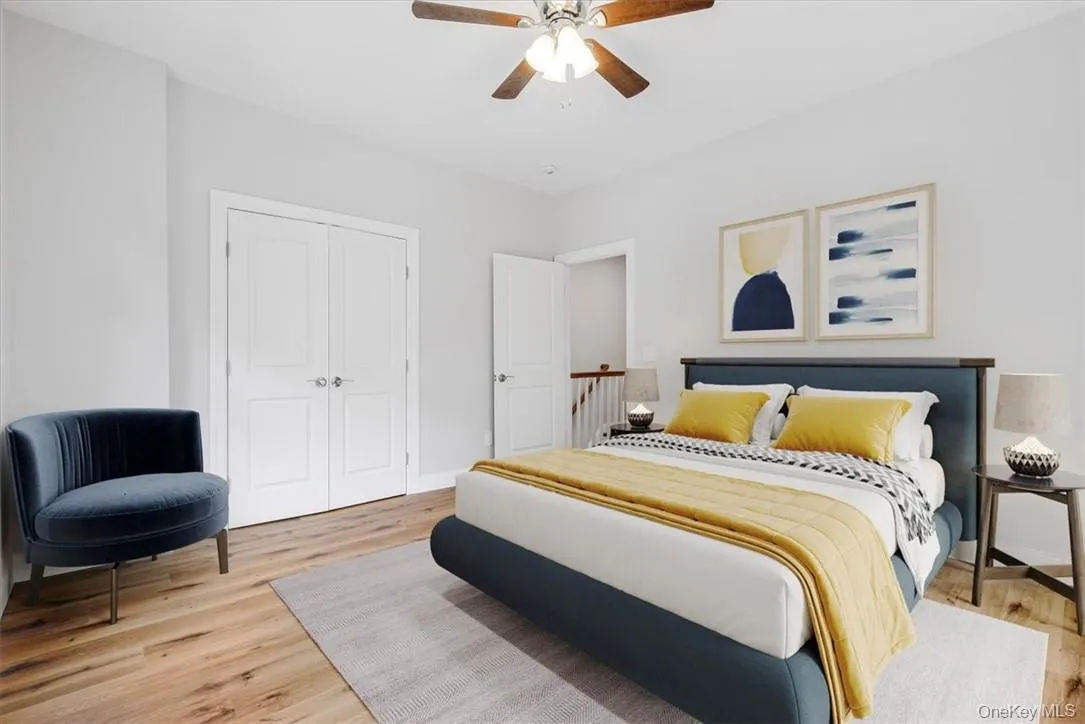Bedroom featuring ceiling fan, a closet, and hardwood / wood-style flooring *Virtually Staged Bedroom featuring ceiling fan, a closet, and hardwood / wood-style flooring *Virtually Staged