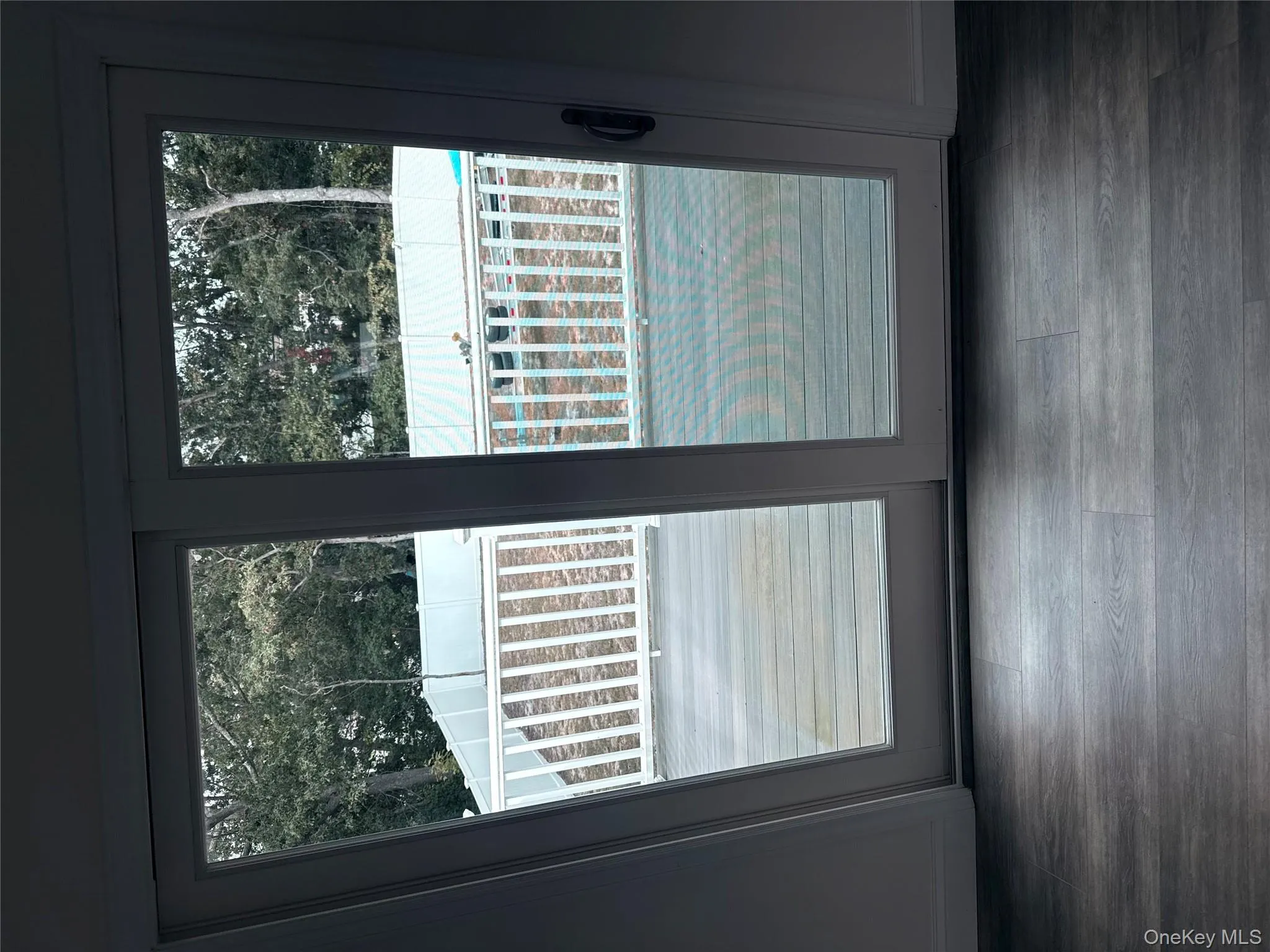 Doorway to outside with healthy amount of natural light, wood finished floors, and view of scattered trees Doorway to outside with healthy amount of natural light, wood finished floors, and view of scattered trees