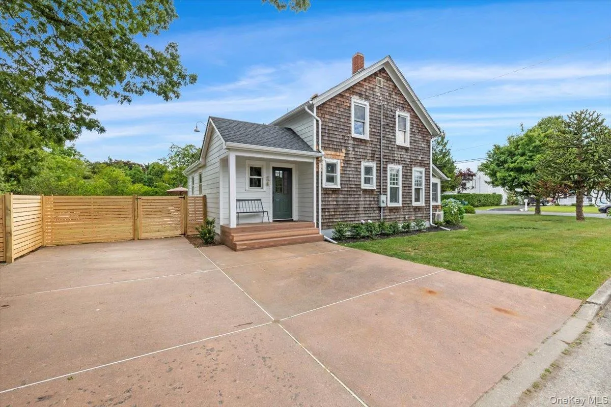 View of front of home featuring a porch, a shingled roof, a chimney, and a gate View of front of home featuring a porch, a shingled roof, a chimney, and a gate