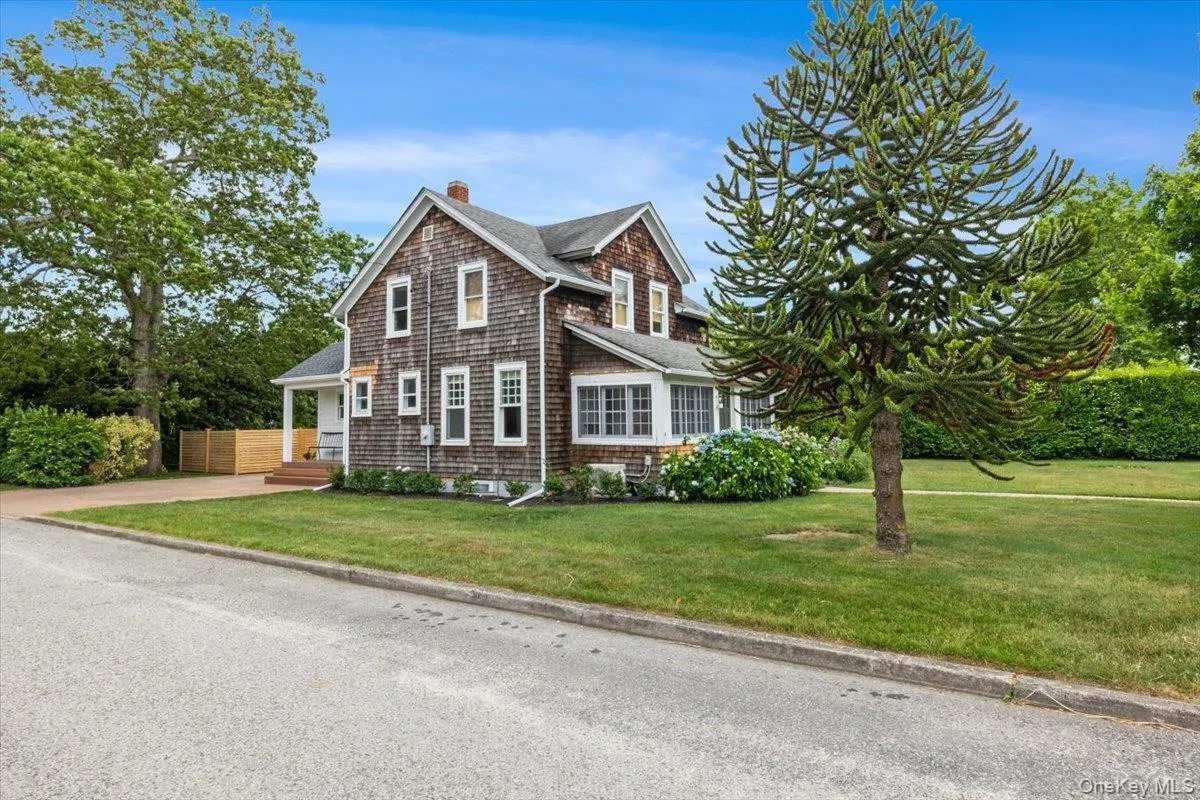 View of front of home with a front lawn, a chimney, and roof with shingles View of front of home with a front lawn, a chimney, and roof with shingles