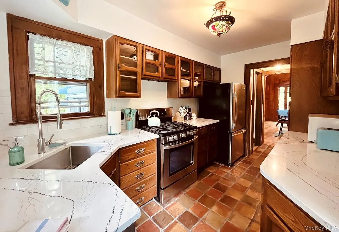 Newly updated kitchen featuring a gas stove, dishwasher, and full-size refrigerator. Newly updated kitchen featuring a gas stove, dishwasher, and full-size refrigerator.