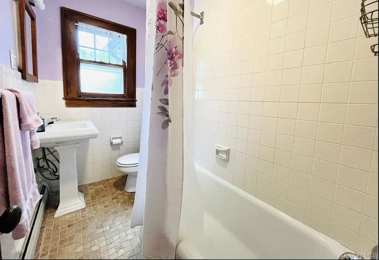 Full bathroom with tub and shower. Full bathroom with tub and shower.