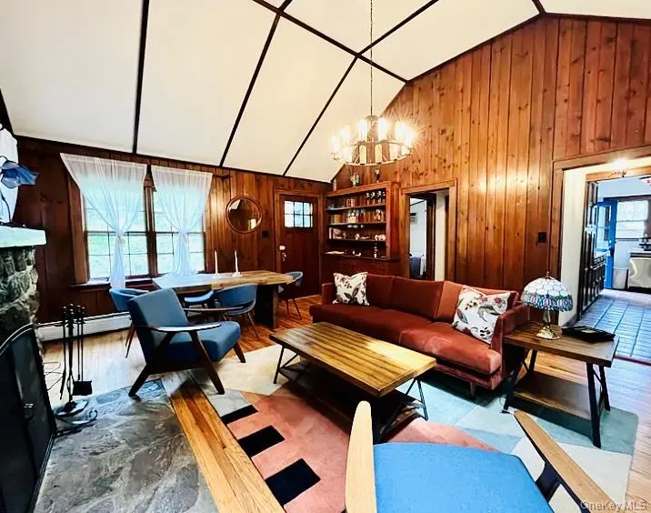 Spacious living room with a working fireplace, cozy sofa, and dining area. Spacious living room with a working fireplace, cozy sofa, and dining area.