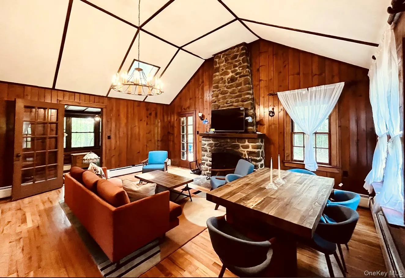 Spacious living room with a working fireplace, cozy sofa, and dining area. Spacious living room with a working fireplace, cozy sofa, and dining area.