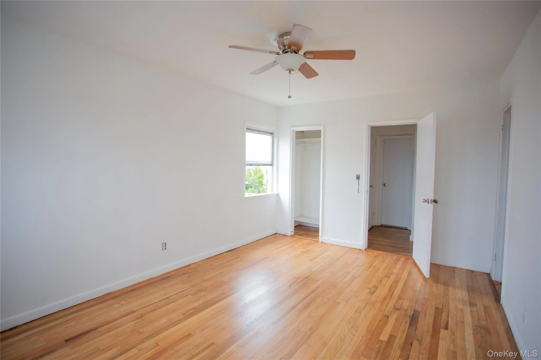 Unfurnished bedroom with light wood-type flooring, ceiling fan, and a closet Unfurnished bedroom with light wood-type flooring, ceiling fan, and a closet
