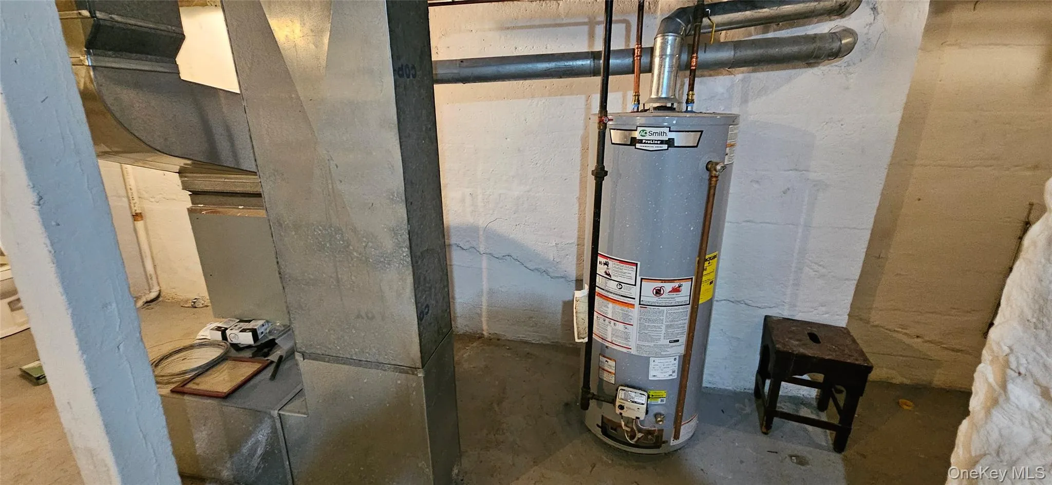 Utility room featuring water heater and heating unit Utility room featuring water heater and heating unit