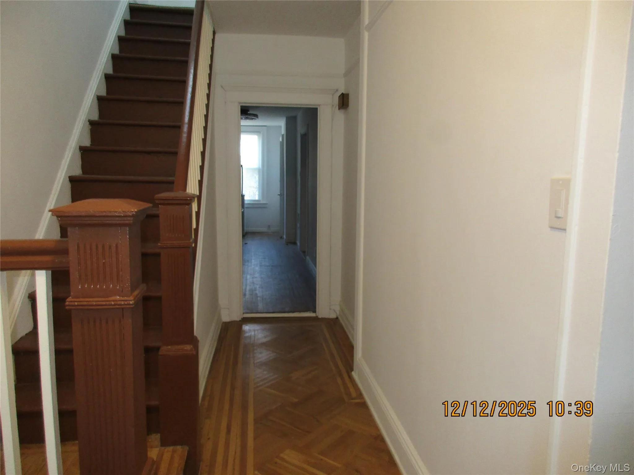Corridor featuring baseboards and stairway Corridor featuring baseboards and stairway