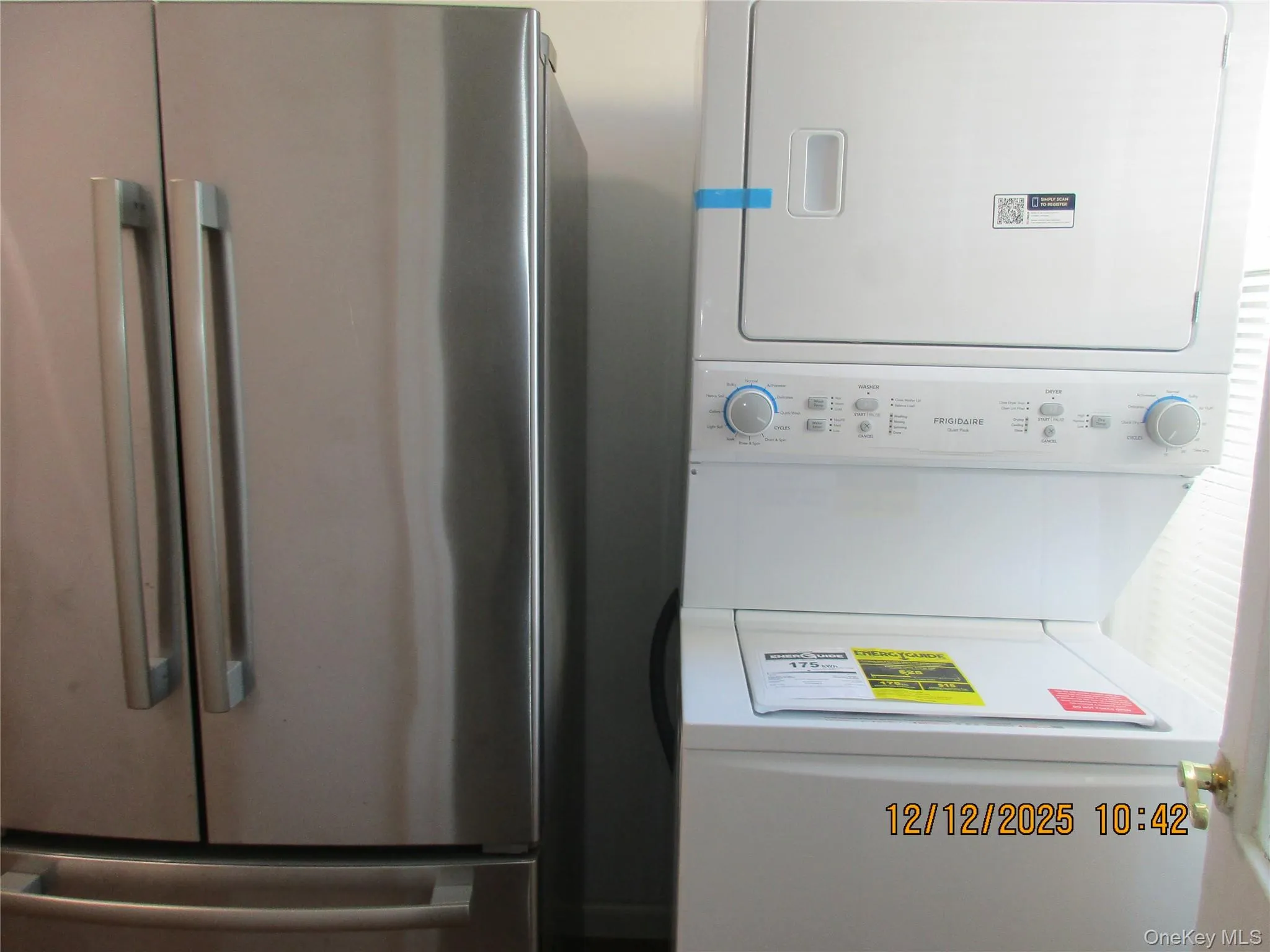 Laundry room with stacked washing machine and dryer Laundry room with stacked washing machine and dryer