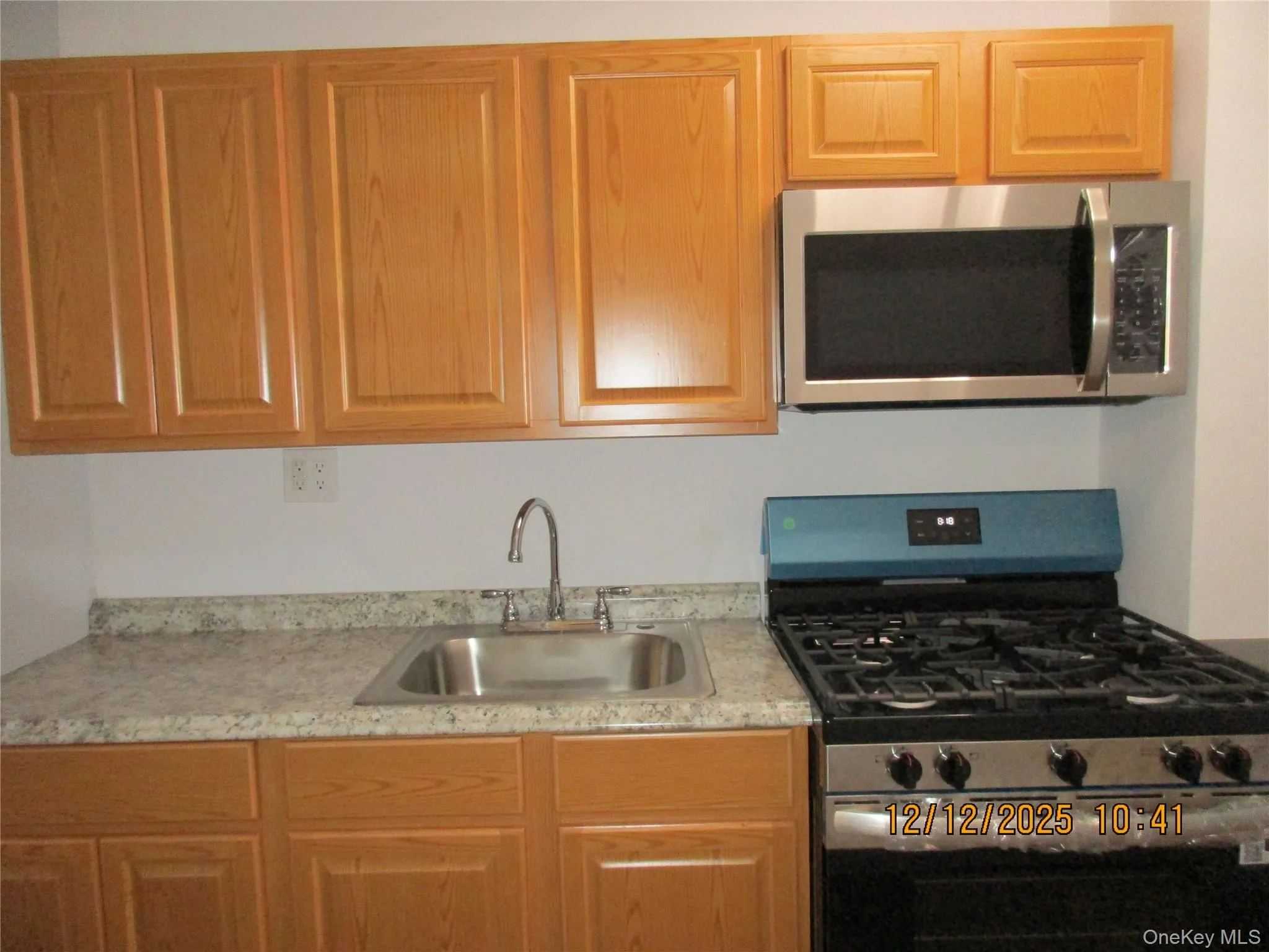Kitchen featuring appliances with stainless steel finishes and brown cabinets Kitchen featuring appliances with stainless steel finishes and brown cabinets