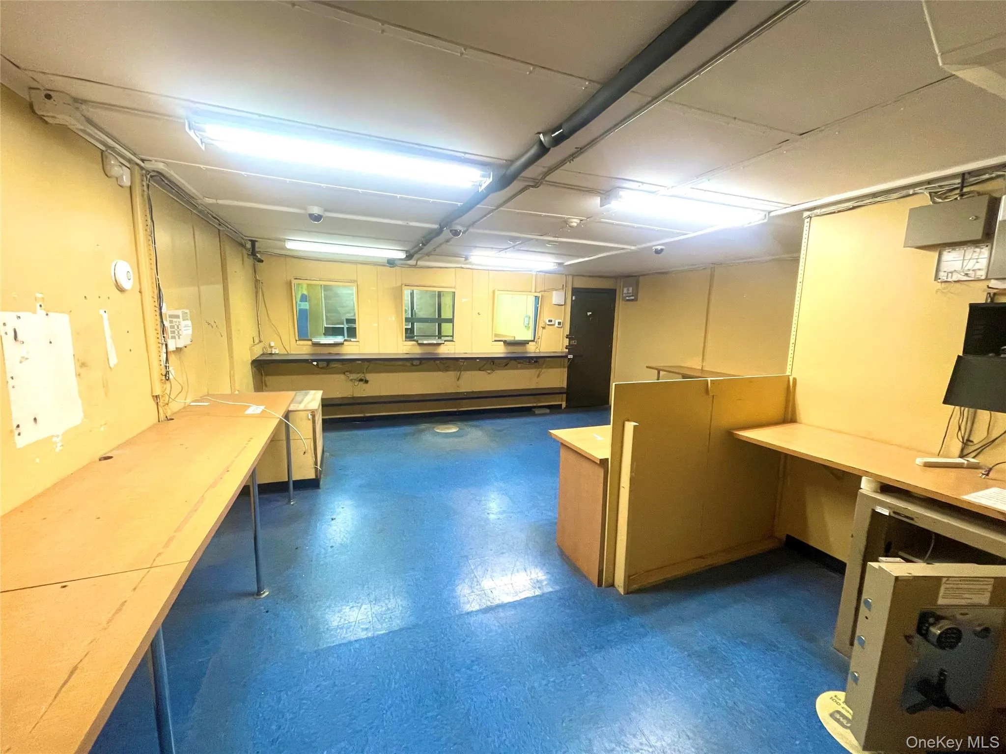 Basement with dark floors and a workshop area Basement with dark floors and a workshop area