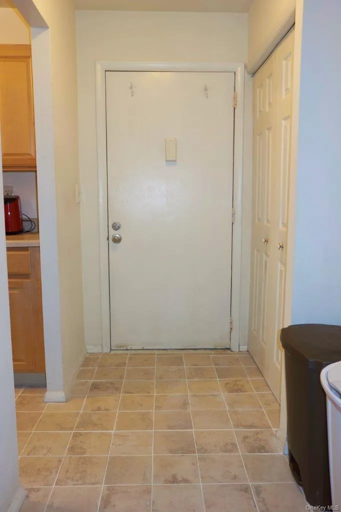 Hall featuring light tile patterned floors Hall featuring light tile patterned floors