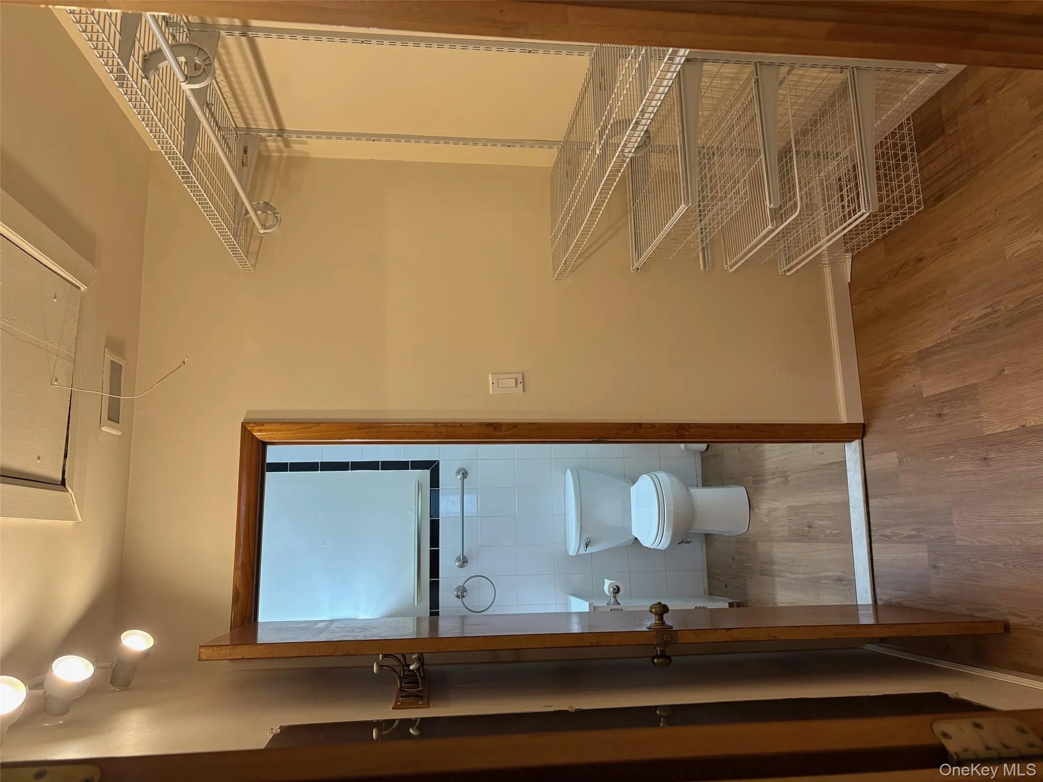 Spacious closet with light wood-style flooring and attic access Spacious closet with light wood-style flooring and attic access