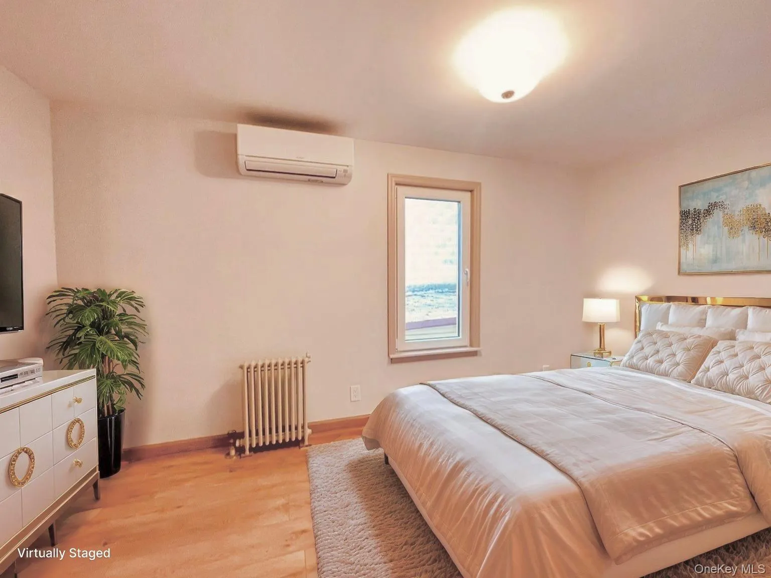 Bedroom with radiator, light wood-type flooring, and an AC wall unit Bedroom with radiator, light wood-type flooring, and an AC wall unit