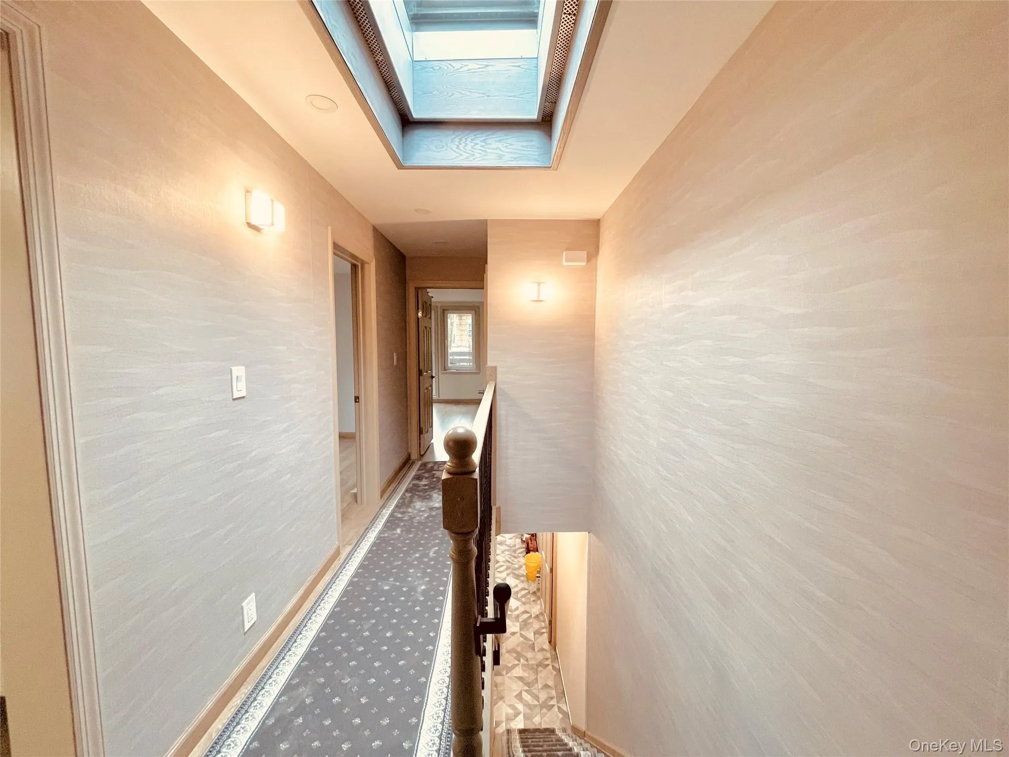 Corridor with baseboards and a skylight Corridor with baseboards and a skylight