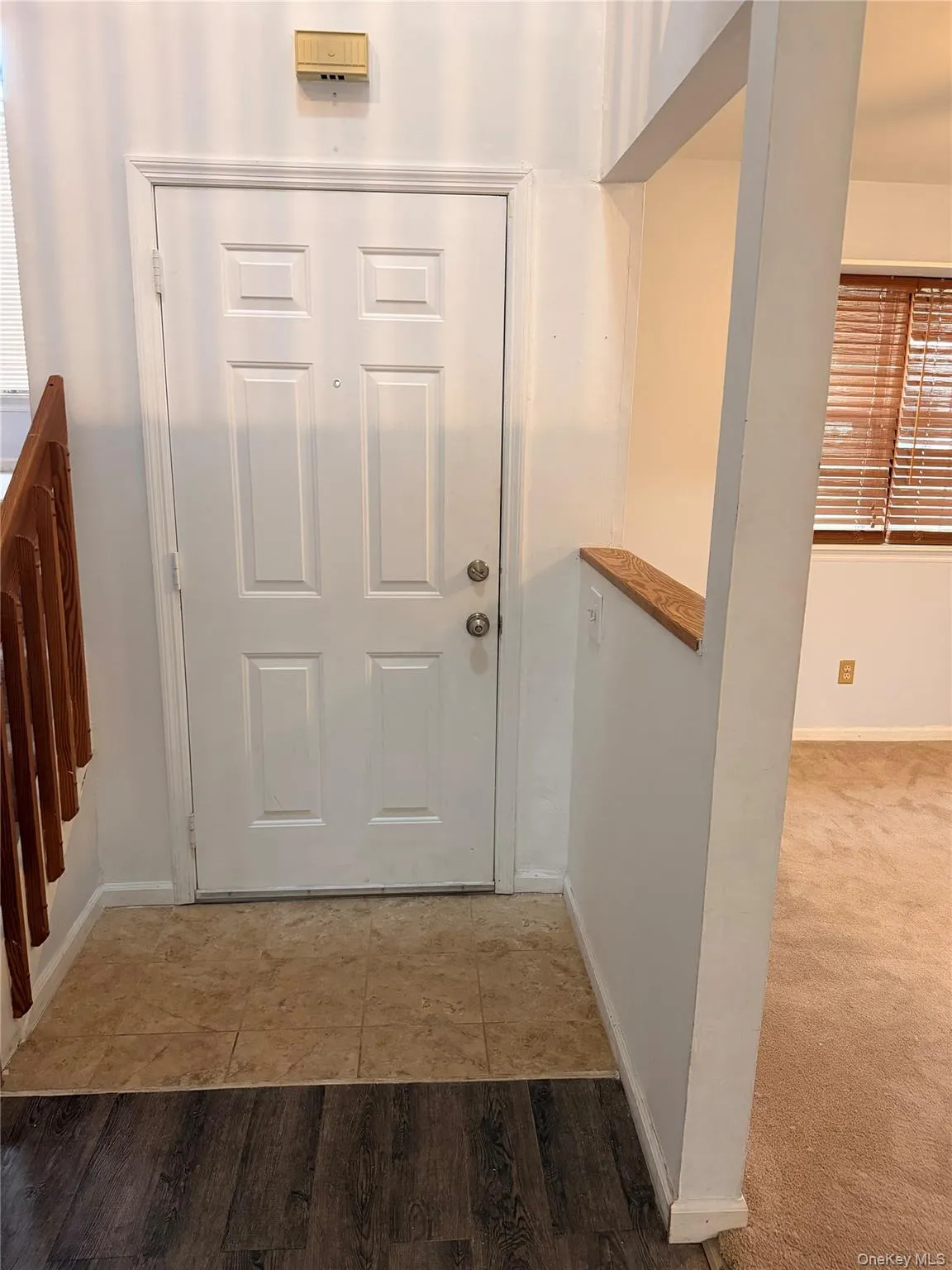 Tiled entrance foyer featuring baseboards Tiled entrance foyer featuring baseboards