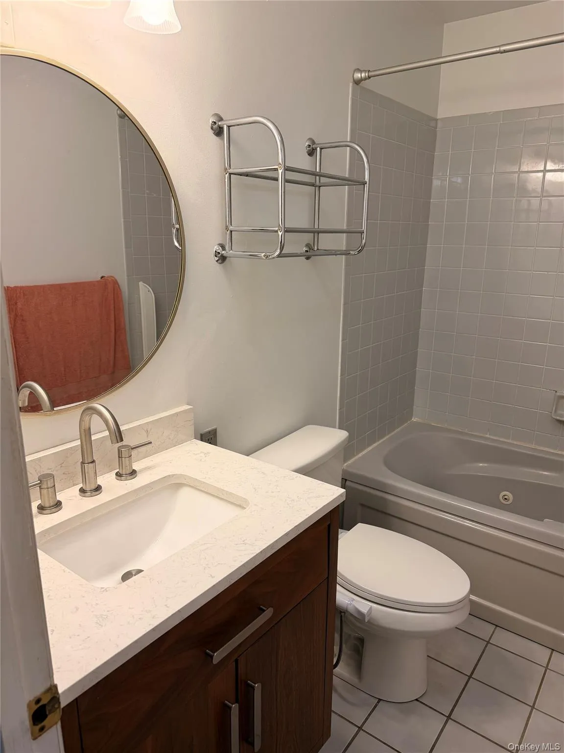 Full bath featuring shower combination, light tile patterned floors, and vanity Full bath featuring shower combination, light tile patterned floors, and vanity