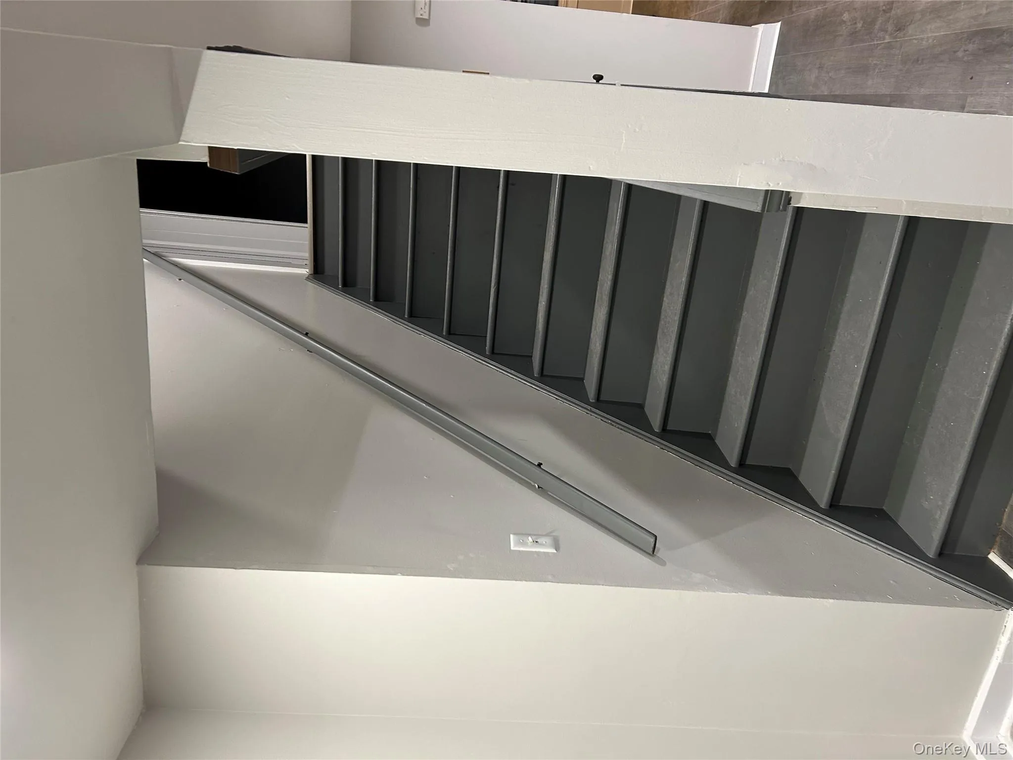 Staircase featuring wood finished floors and baseboards Staircase featuring wood finished floors and baseboards