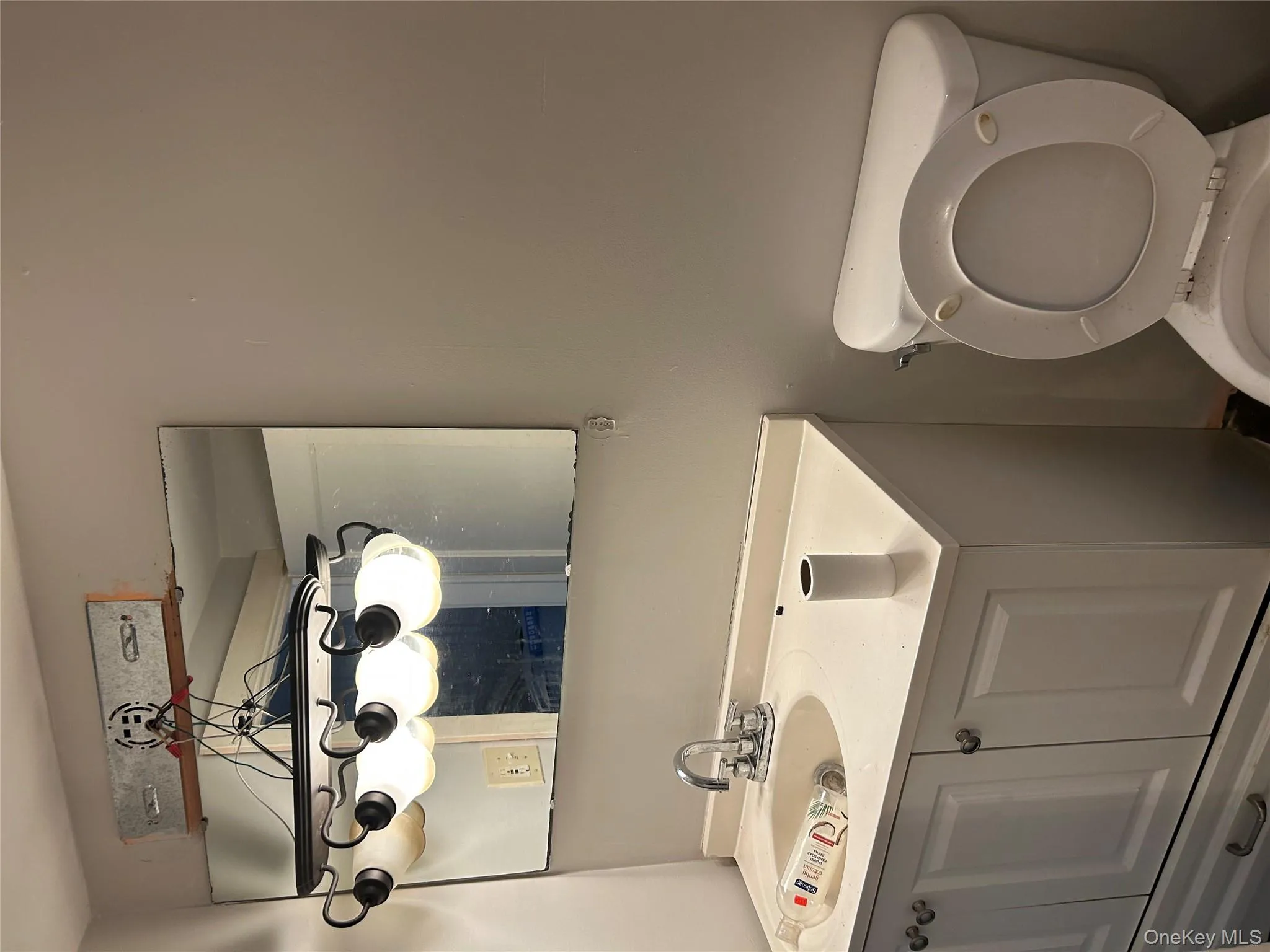 Half bathroom featuring vanity and toilet Half bathroom featuring vanity and toilet