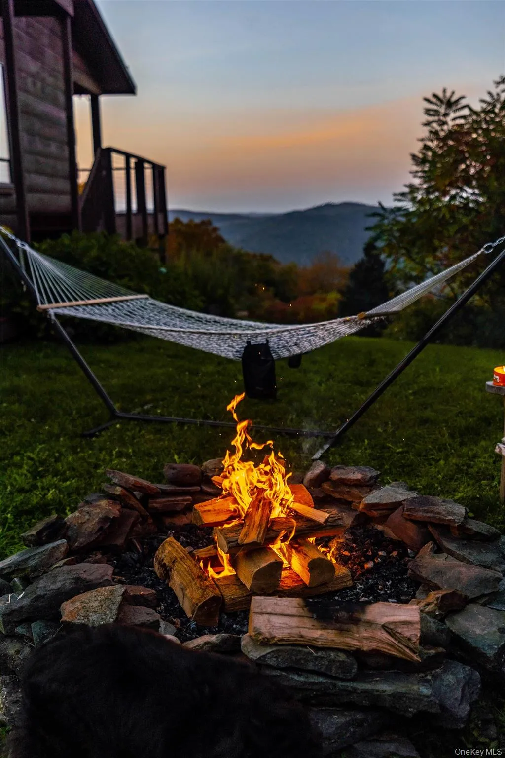View of green lawn with a fire pit and a mountain view View of green lawn with a fire pit and a mountain view