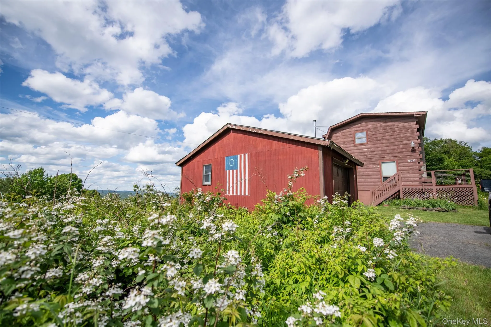 View of home's exterior featuring a wooden deck View of home's exterior featuring a wooden deck