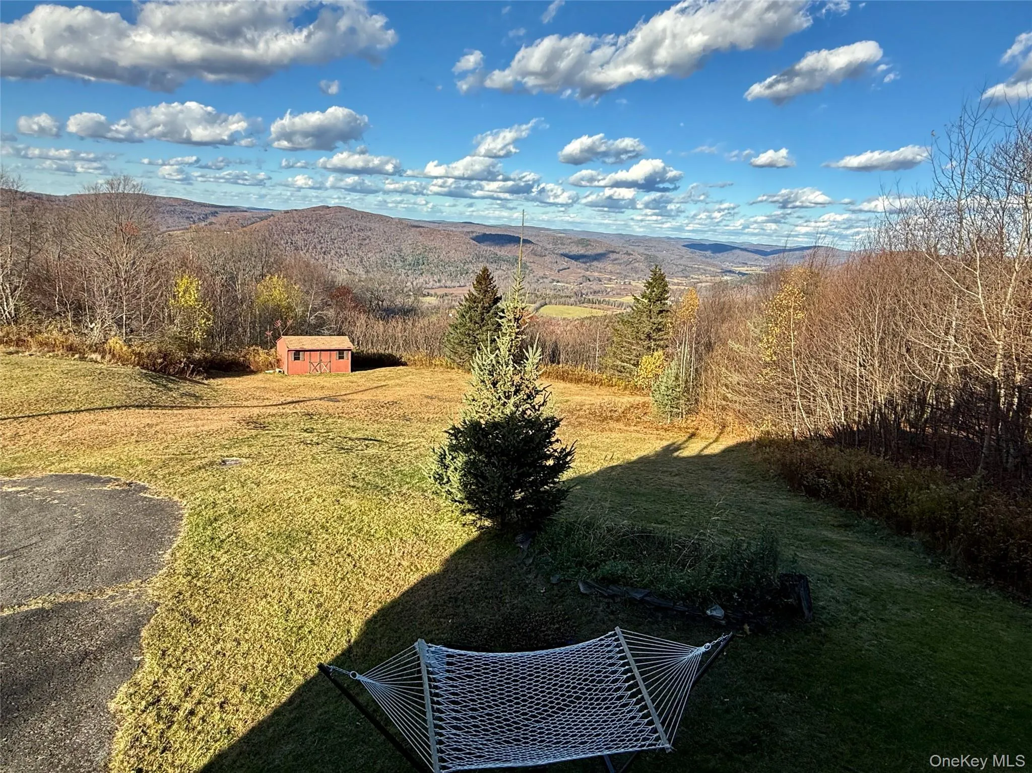 View of green lawn featuring a shed and a mountain view View of green lawn featuring a shed and a mountain view