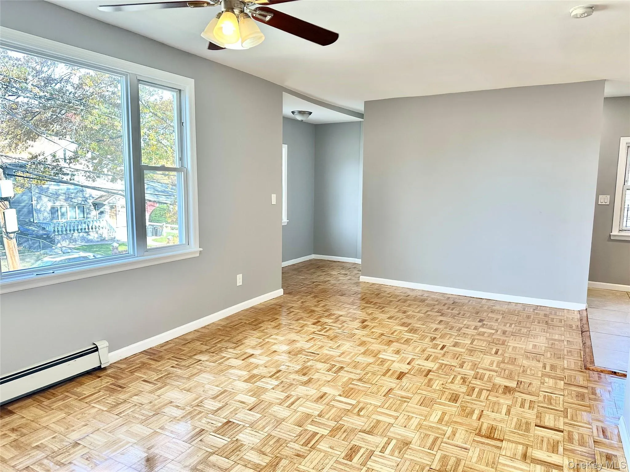Empty room with ceiling fan and baseboards Empty room with ceiling fan and baseboards