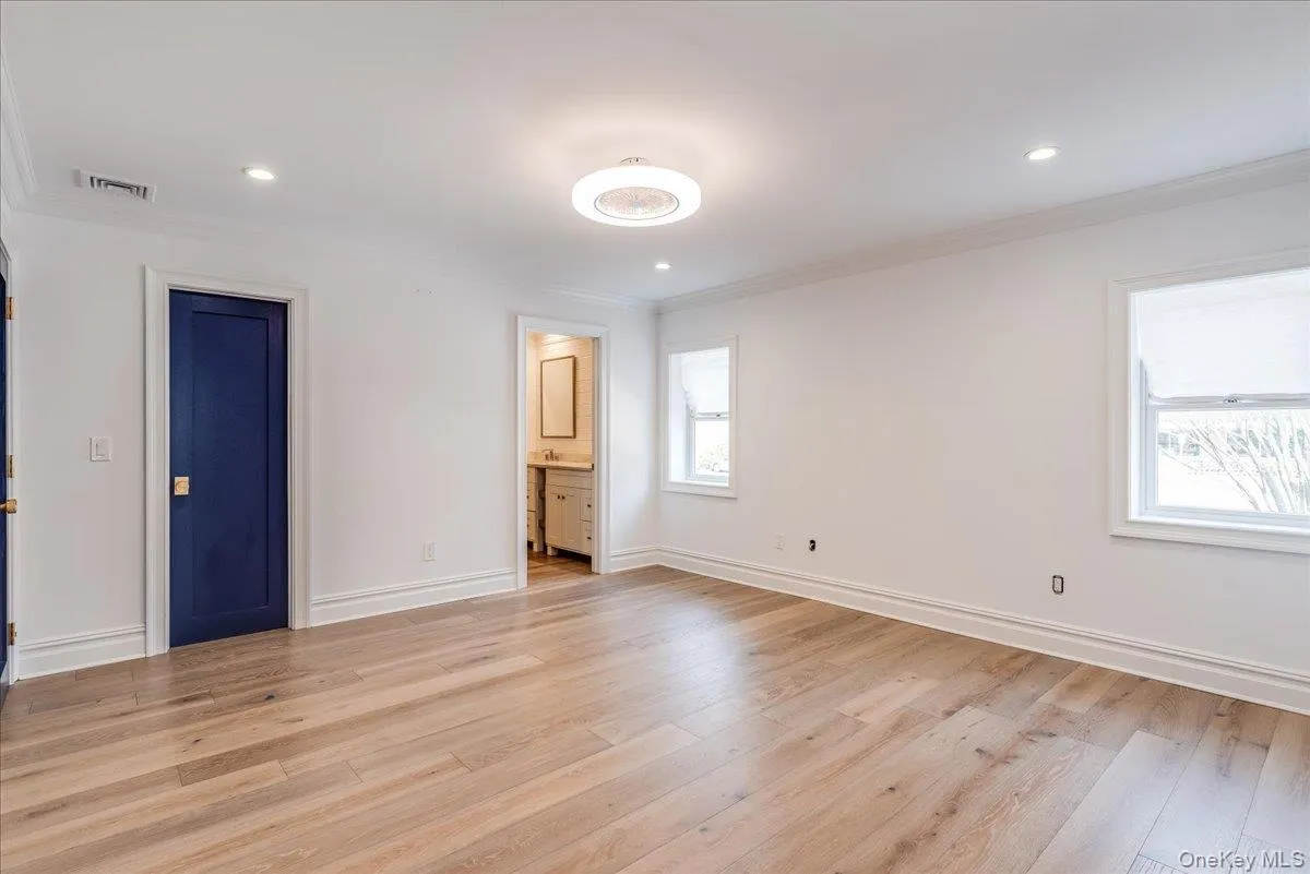Unfurnished bedroom featuring ornamental molding, light wood finished floors, recessed lighting, and ensuite bathroom Unfurnished bedroom featuring ornamental molding, light wood finished floors, recessed lighting, and ensuite bathroom
