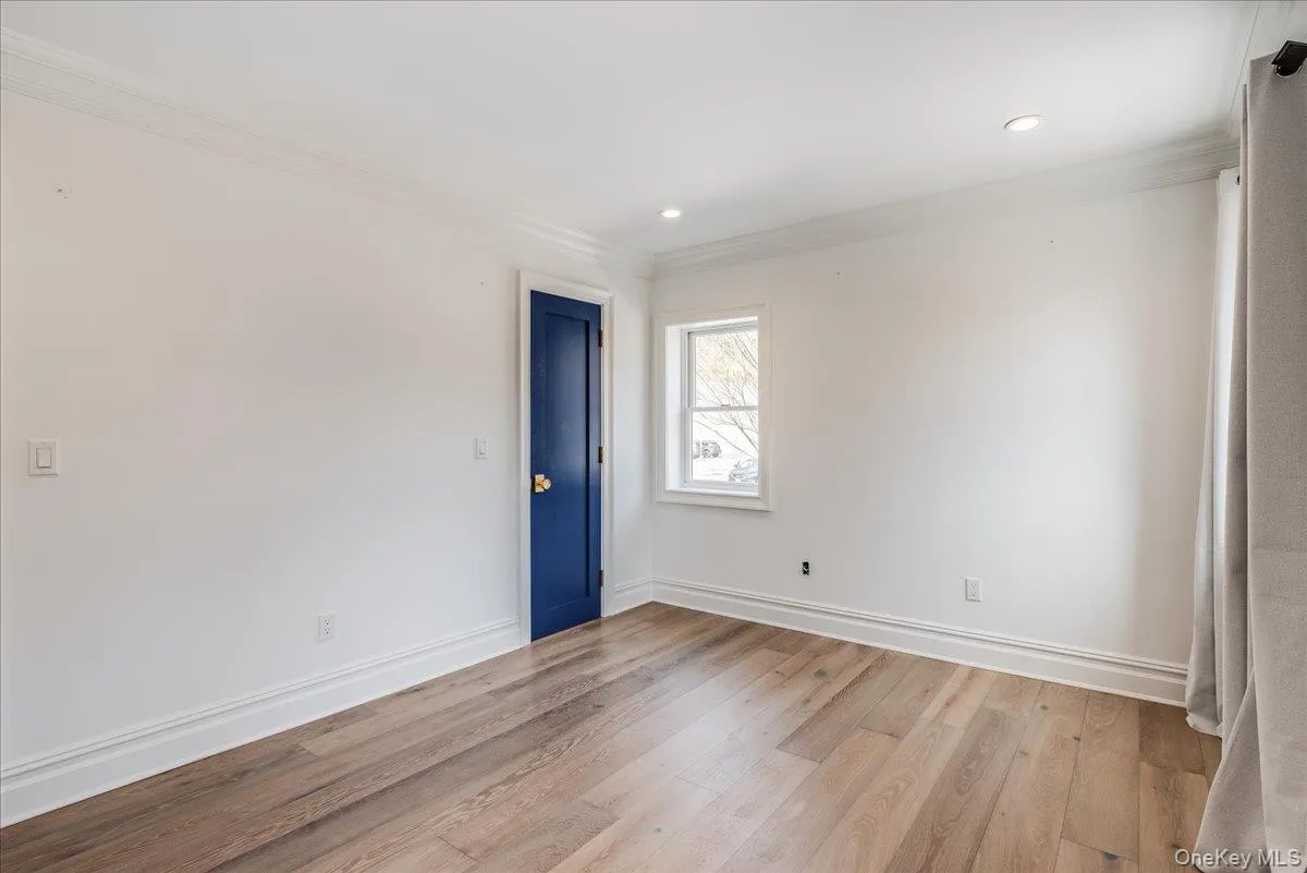 Unfurnished room with light wood finished floors, ornamental molding, and recessed lighting Unfurnished room with light wood finished floors, ornamental molding, and recessed lighting