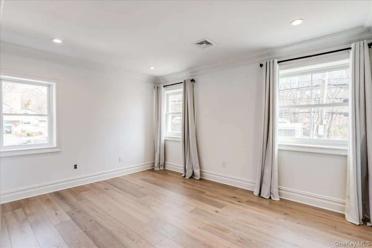 Spare room featuring crown molding, light wood-type flooring, and recessed lighting Spare room featuring crown molding, light wood-type flooring, and recessed lighting
