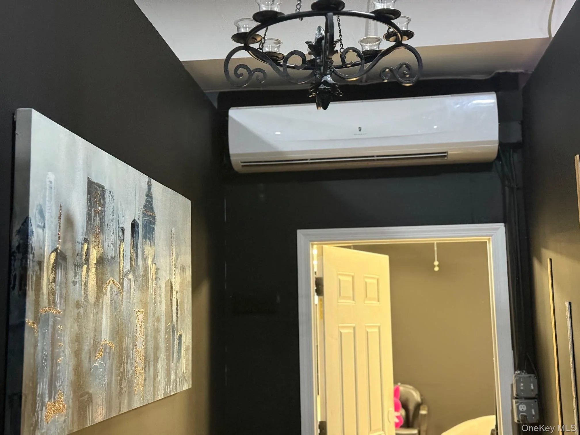 Detailed view of a wall mounted air conditioner and a chandelier Detailed view of a wall mounted air conditioner and a chandelier